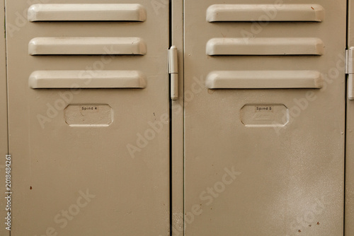 Detail of vintage school lockers showing ventilation slots and identification tags