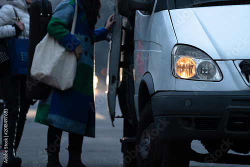 Fotografija Public transport bus picking up passengers at a designated stop, illustrating urban mobility, daily commuting, organized transit system, and passenger boarding in city environment