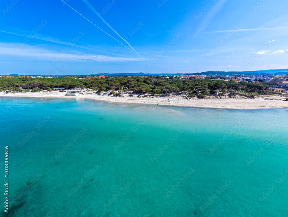 Fototapeta premium Aerial view from the sea of Maria Pia beach coastline under a blue sky