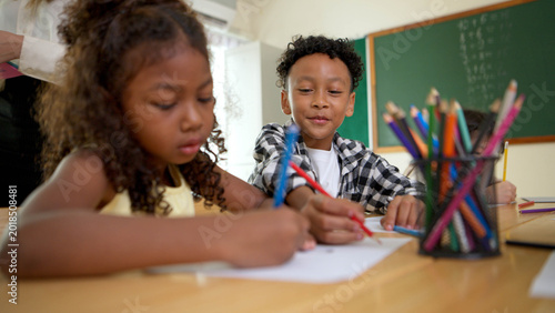 Фотография Young students are learning to draw and sketch with colored pencils