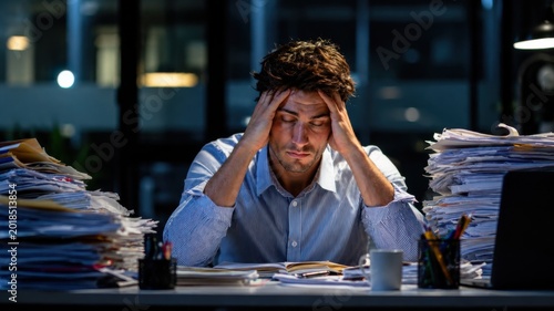 Overworked Businessman Facing Burnout At Night