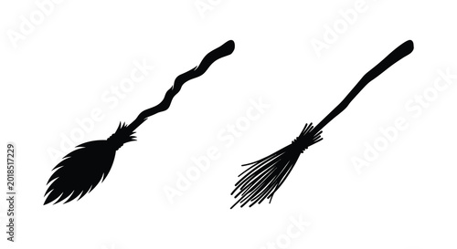 Valokuva Two witch brooms in black silhouette against a white background