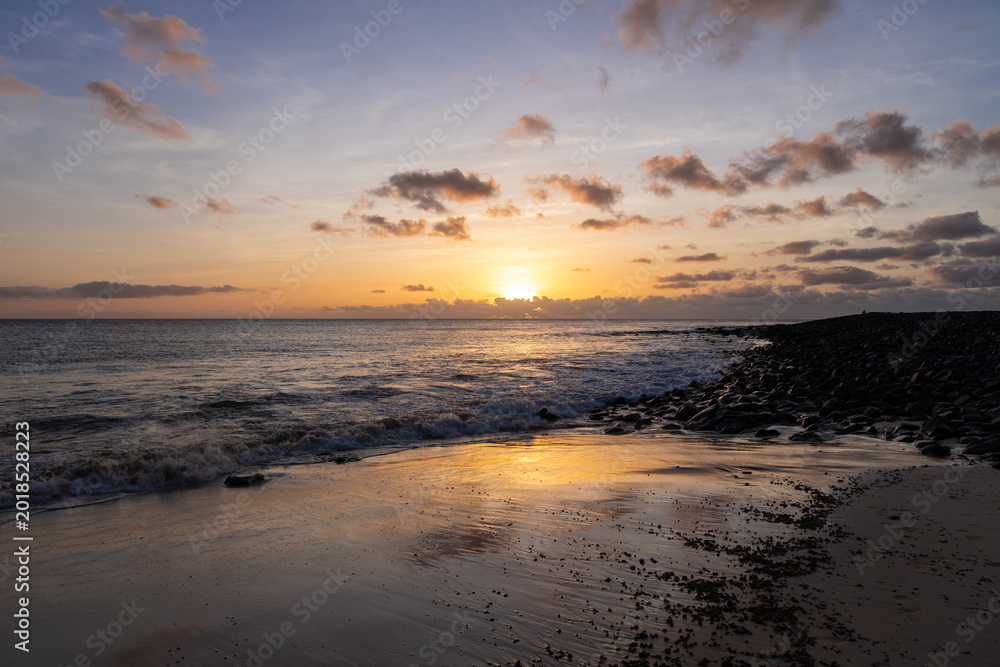 Obraz premium Amazing colorful sunset over the Ponta Preta beach (Black tip beach) on the southern part of the beautiful island of Sal in Cape Verde. The popular beach is isolated and deserted but gives amazing vie