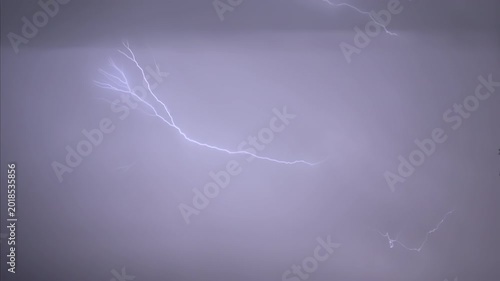 Isolated lightning bolt in the night sky, captured in slow motion.