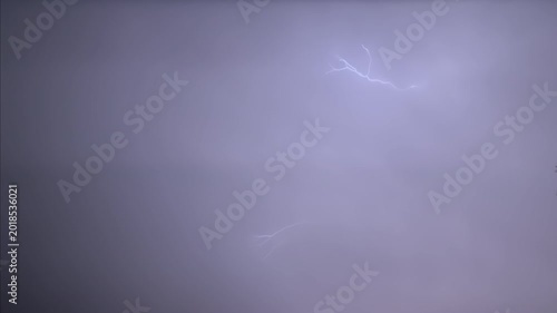 Isolated lightning bolt in the night sky, captured in slow motion.