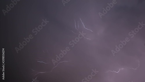 Isolated lightning bolt in the night sky, captured in slow motion.
