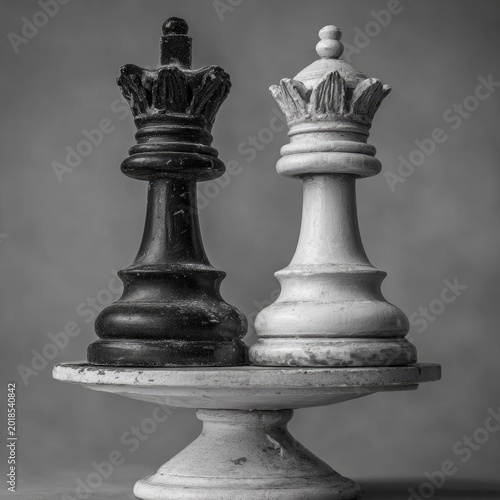 Black and White Chess Queens on Pedestal