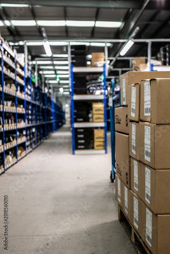 Canvastavla Modern warehouse interior featuring blue metal racking systems and vertical shelving designed to maximise storage space for industrial goods and spare parts