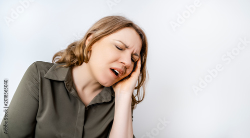 Woman feeling sharp toothache holding cheek. Dental health concept. Stomatology emergency gingivitis sensitive teeth.