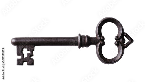 Foto Antique ornate iron key with decorative bow and rustic shaft