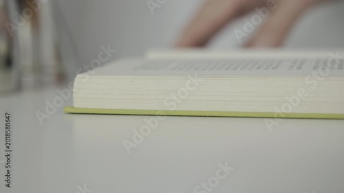 Opened book on white table
