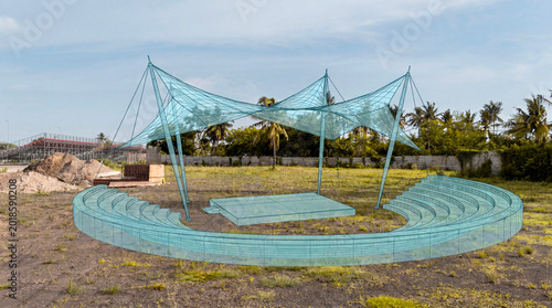 Amphitheater wireframe overlay on undeveloped coastal land showing tensile canopy structure design