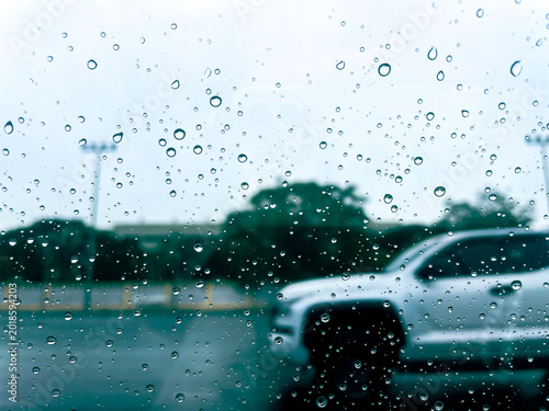 Water drop on glass and windshield rain car on road