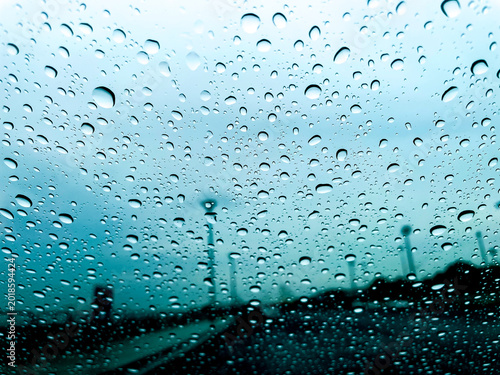 Water drop on glass and windshield rain car on road