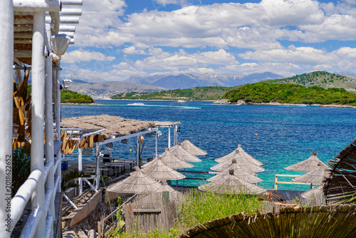 sunshades and sunbeds on the  beach of Ksamil , Albania , touristic destination