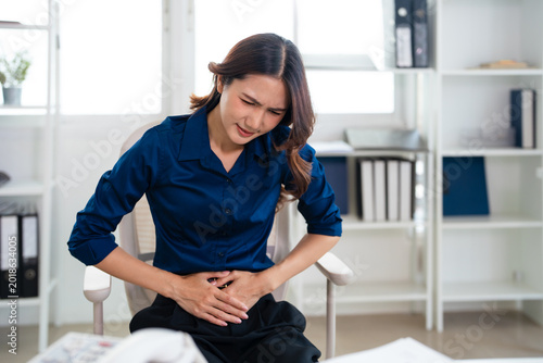Bild auf Leinwand Young asian woman business worker suffering for stomach ache at office