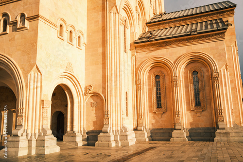 Architectural detail of the stone arches and columns at the entrance of Holy Trinity Cathedral (Sameba) in Tbilisi, Georgia. Traditional Georgian Orthodox craftsmanship on a grand scale