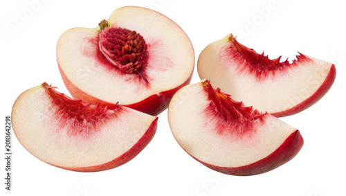 Sliced white peaches with red blush and fuzzy pits arranged closely