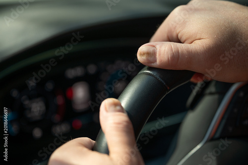 Εκτύπωση καμβά Close-up of damaged fingernails on male driver hands holding steering wheel