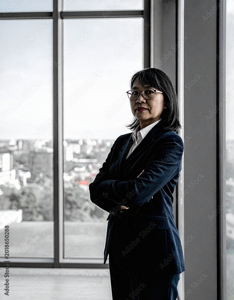 Fototapeta premium portrait of sophisticated mature asian businesswoman executive with glasses