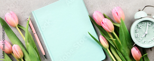 Spring Workspace Flat Lay with Tulips Notebook Glasses and Clock