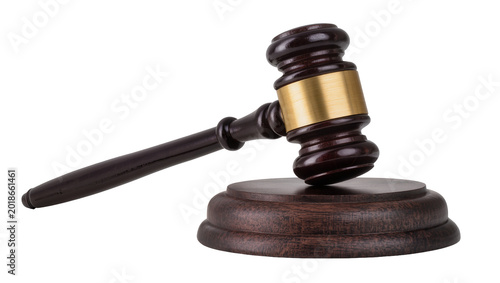 Obraz na plátně Wooden gavel with brass band resting on dark wooden base