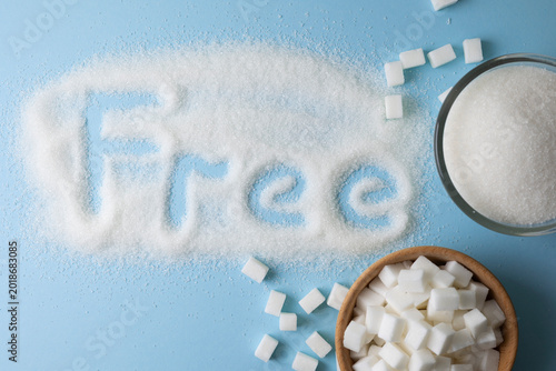 White sugar and the inscription ''sugar free'' on a colored background