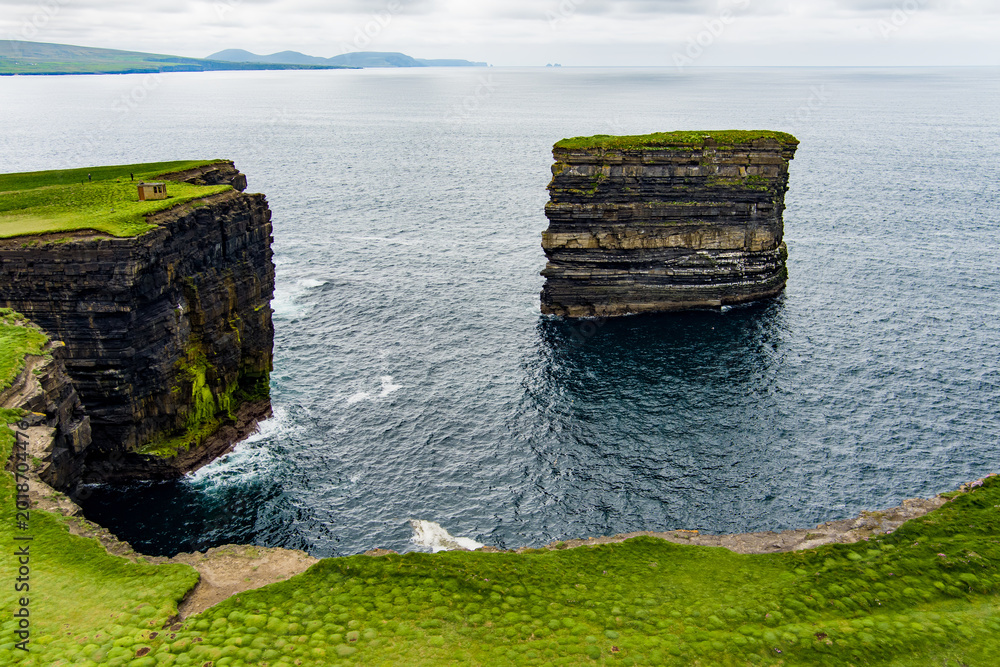 Fototapeta premium Aerial view of Dun Briste sea stack at Downpatrick Head, County Mayo, Ireland. Spectacular layered cliffs and Atlantic waves on the Wild Atlantic Way.