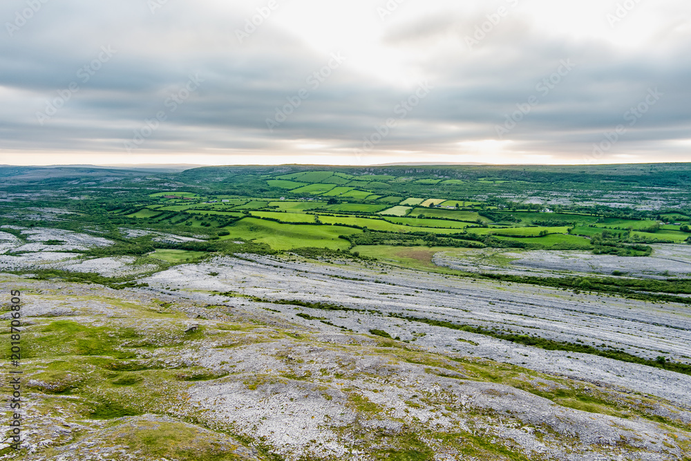Fototapeta premium Aerial view of Burren National Park in County Clare, Ireland. Dramatic limestone karst landscape on the Wild Atlantic Way with green fields and wild countryside.
