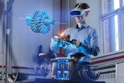 Caucasian male engineer using vr for advanced engine design in futuristic workspace, Immersive Technology with AI assistant