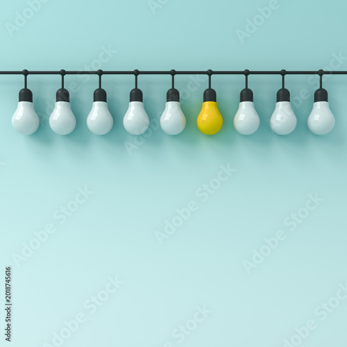 Fotografie Standing out from the crowd and leadership one hanging yellow bright idea bulb w