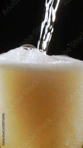 Craft Beer Pouring Into Glass in Super Slow Motion at a Bar With Foam and Bubbles for a Party Drink Experience