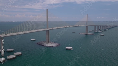Cinematic aerial drone push toward Sunshine Skyway Bridge over Tampa Bay