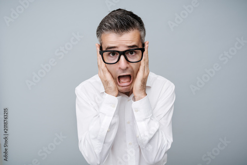 Fotografi Shocked man with head in hands