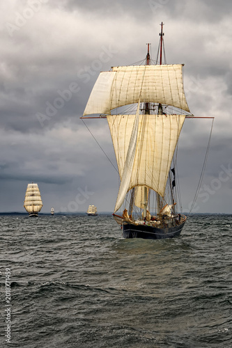 Sailing ships under white sails at the regatta	