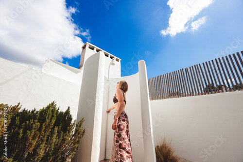 Bild auf Leinwand Woman enjoying outdoor shower during summer vacation