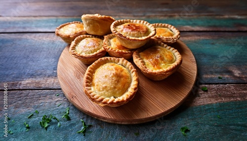 classic australian mini meat pie on wood filled with vegetables savory pastry treat