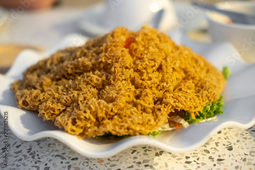 Crispy fluffy fried fish served with a green mango salad, Thai food