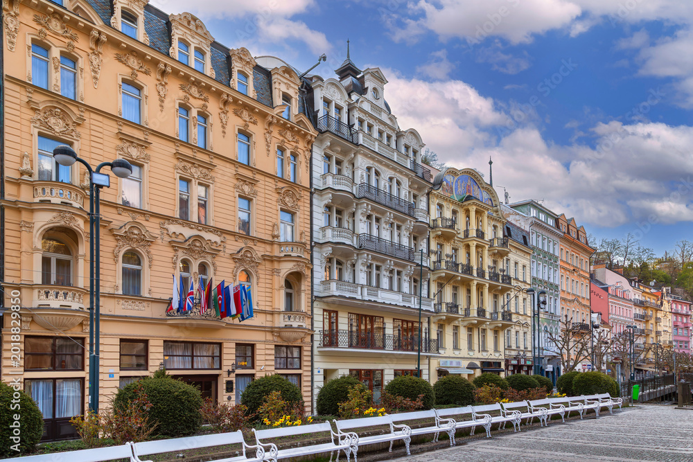 Fototapeta premium Historic building facades in Karlovy Vary, Czech Republic. Colorful neorenaissance architecture under cloudy sky