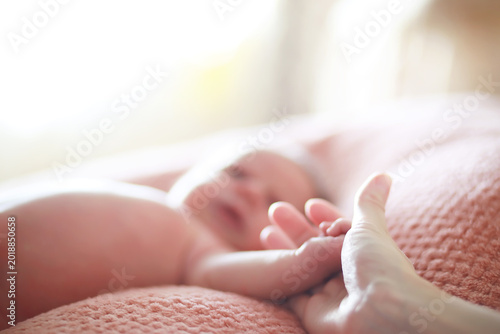 Photos A newborn baby lies in her mother's arms