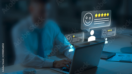 Businessman Managing Online Customer Reviews and Feedback Ratings on Laptop at Night, Digital Reputation Management, Customer Satisfaction Survey, Five Star Review Concept, CRM Technology and User Exp