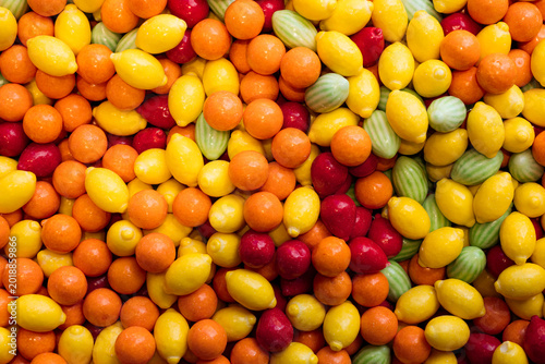 Photos Colorful fruit shaped chewy candies and gum arranged as a sweet background