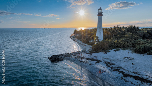 Photography A lighthouse facing the sea on the shore of Miami Beach at a spectacular sunset