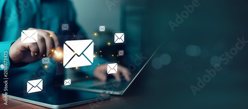 Schilderij op canvas Business professional using digital email marketing interface on laptop and tabl