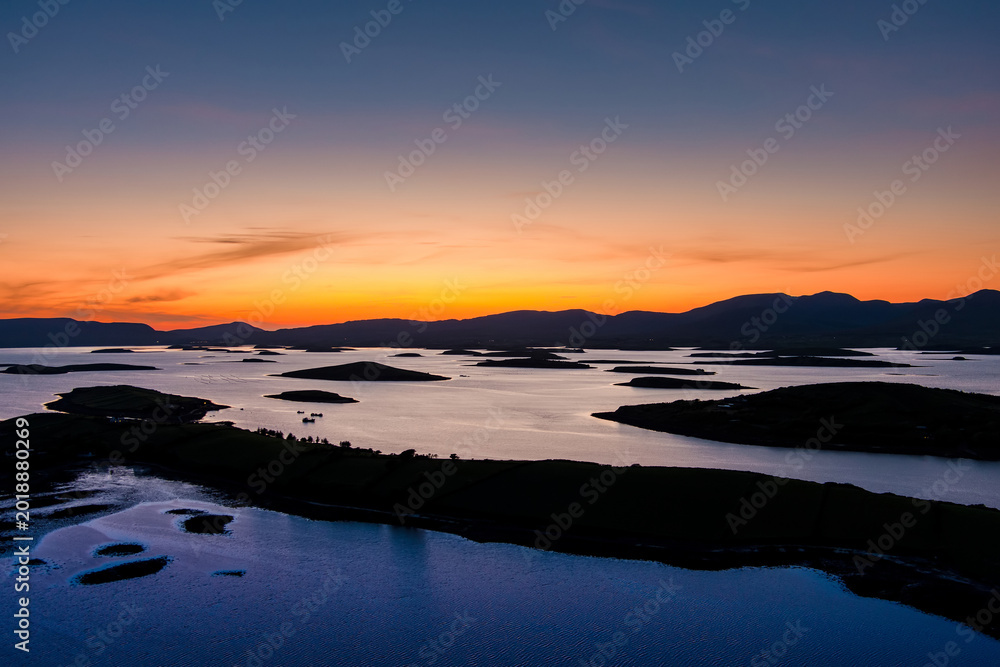 Obraz premium Aerial sunset view over Clew Bay near Westport, County Mayo, Ireland. Scenic Atlantic bay with drumlin islands and mountain silhouettes on the Wild Atlantic Way.