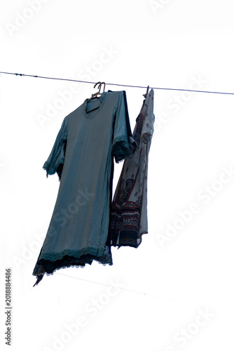 Women churidar suit are hanging on sunlight after ring-dyeing to dry on isolated white background.