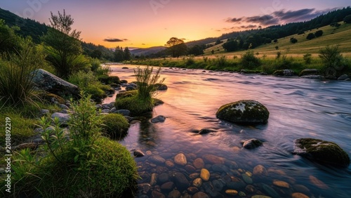 Serene River Flowing Through Lush Green Valley at Sunset.