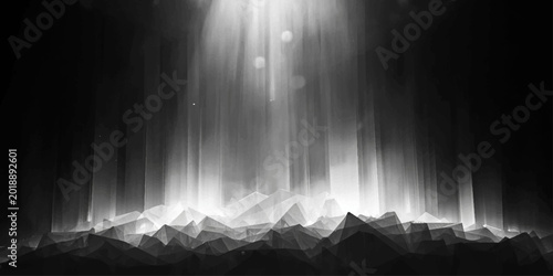 Sunlight pierces through heavy fog and clouds over snow-covered mountains to create a dark blue nature backdrop with a rough vintage grunge texture