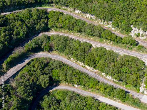 Photos Steep mountain switchbacks and serpentine road winding through Mediterranean for