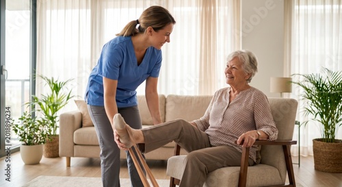Caregiver assisting senior woman with leg exercises at home